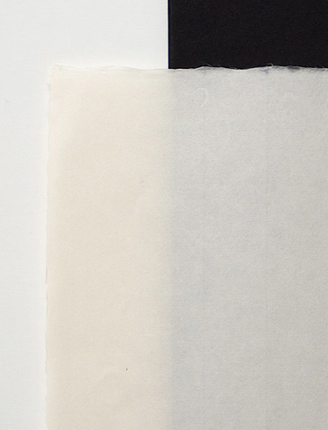 A close-up of a piece of Awagami handmade paper with a textured surface, predominantly white in color.